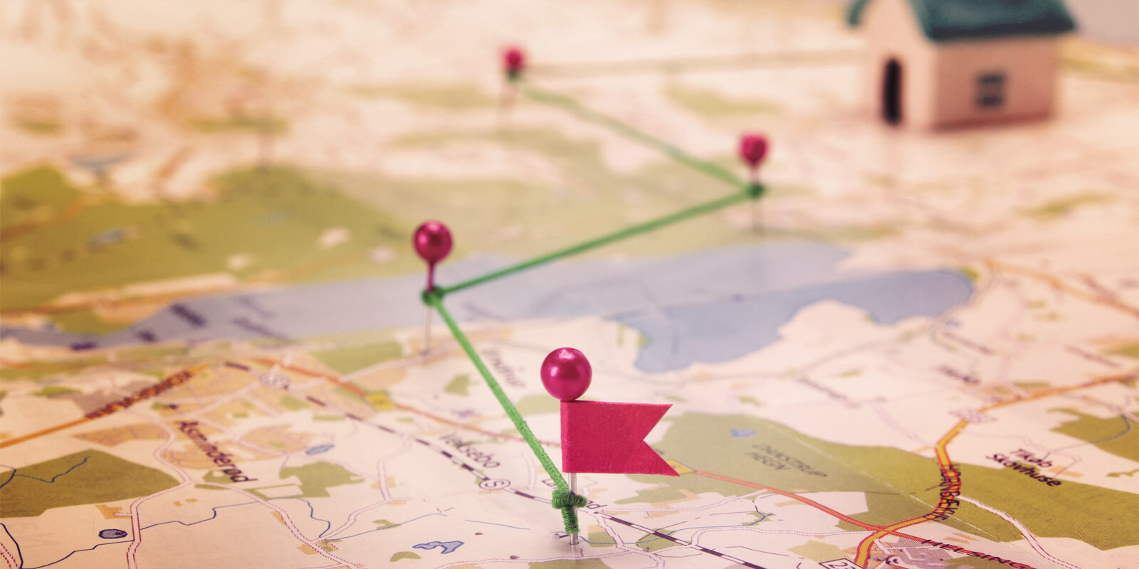 A map with needles on it, that are connected woth a green line