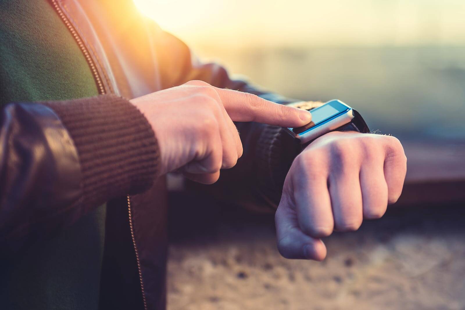 A man is using his smart watch